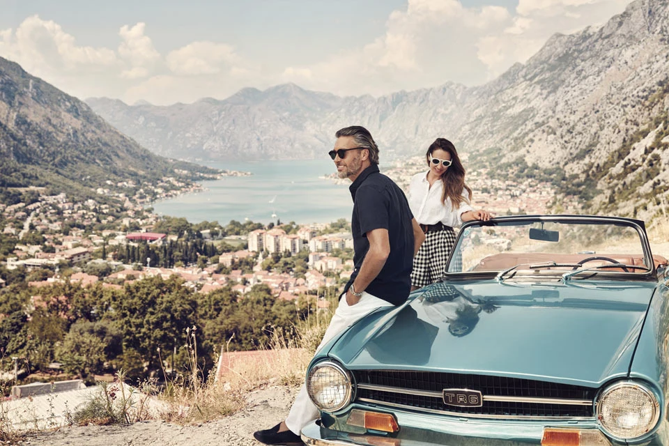 Romantic Couple enjoys the views of Boka Kotor Bay on old-fashioned car